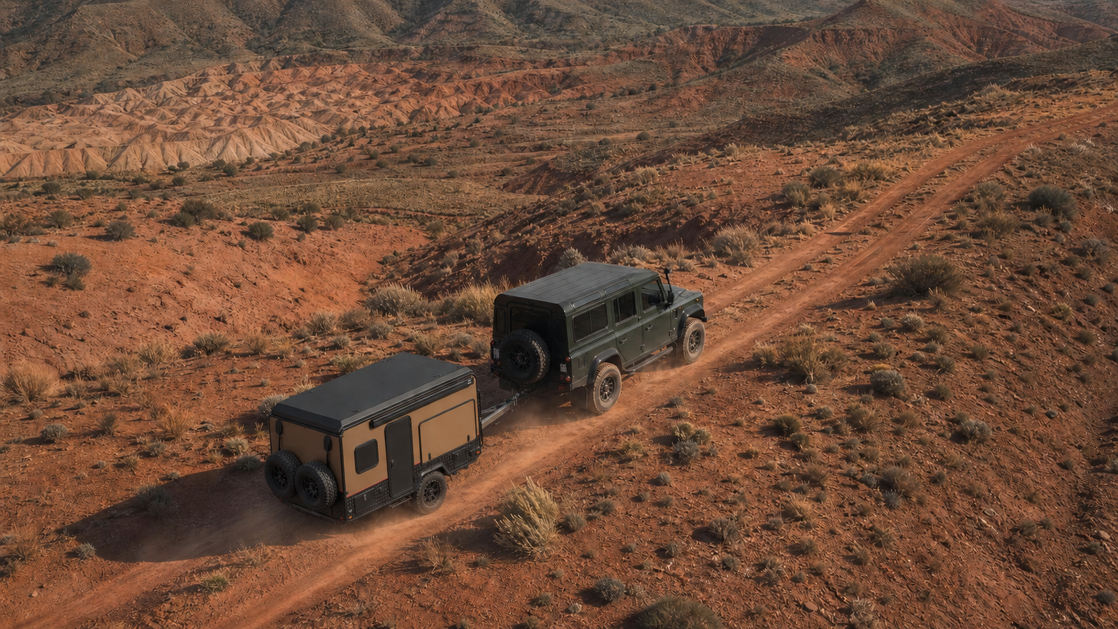 Off-road vehicle towing an AOZI camper trailer through red-earth mountains